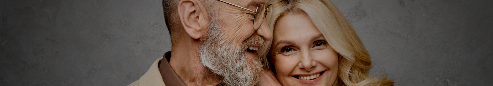 Mature man and woman laughing together