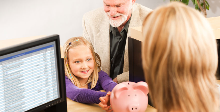 Little girl at bank with piggy bank