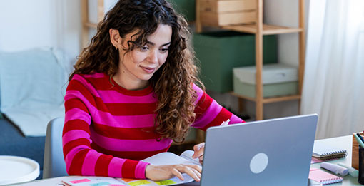 Woman working on computer in home office