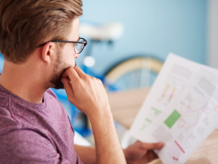 Young man looking over financial reports