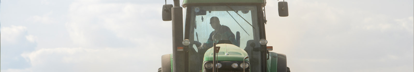 Man riding tractor in field