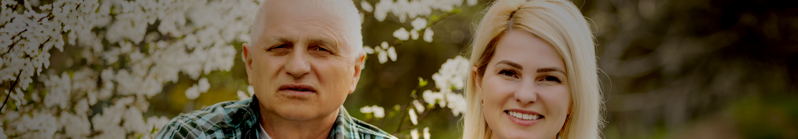 Man and woman smiling together outside